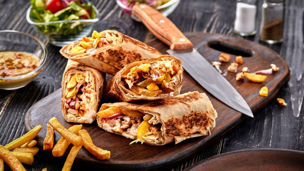 pita Mediterranean street food- Chicken shawarma pita is a favorite among meat lovers. Thinly sliced marinated chicken, cooked to juicy perfection.