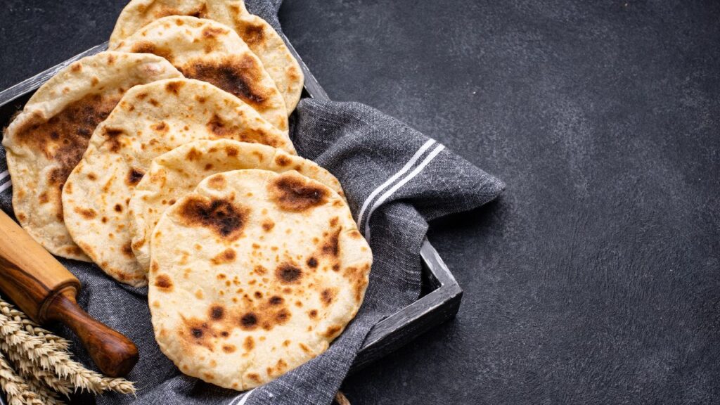 Pita bread is a versatile and soft flatbread with a hollow pocket that serves as the perfect vessel for holding various fillings.