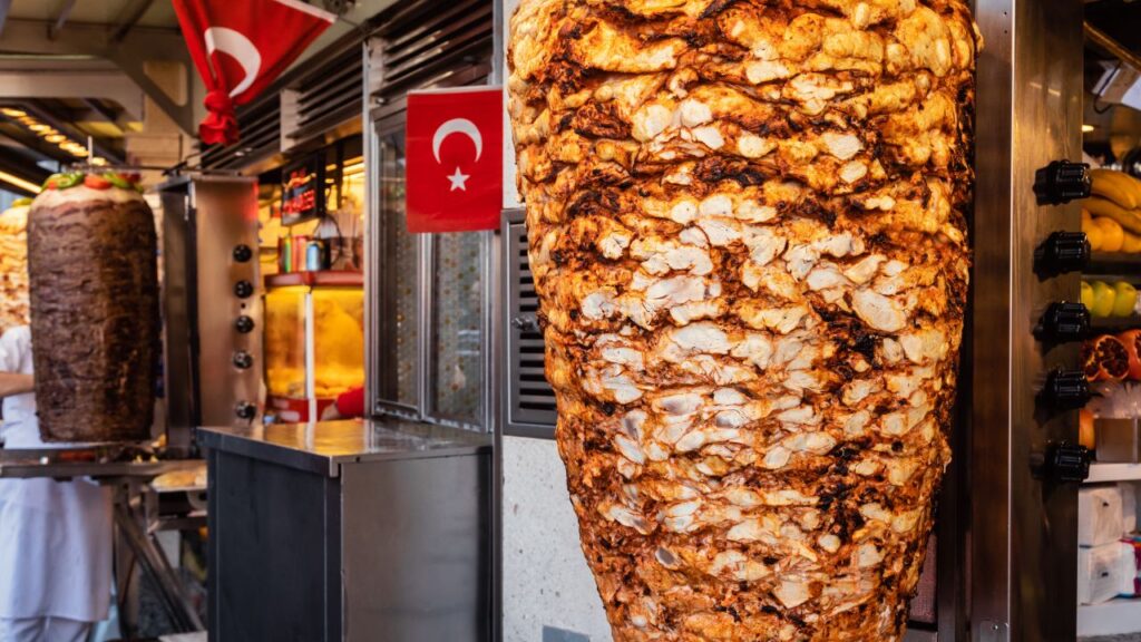 Turkish doner kebab is a mouthwatering street food delight that consists of layers of marinated meat, typically lamb or chicken, stacked on a vertical spit and slow-roasted to perfection.